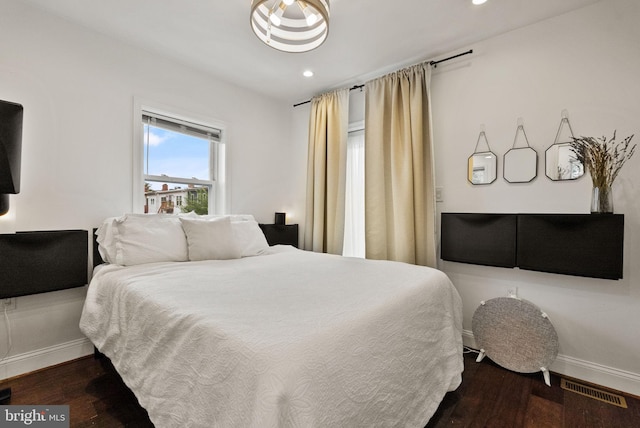 bedroom with recessed lighting, dark wood-style flooring, visible vents, and baseboards