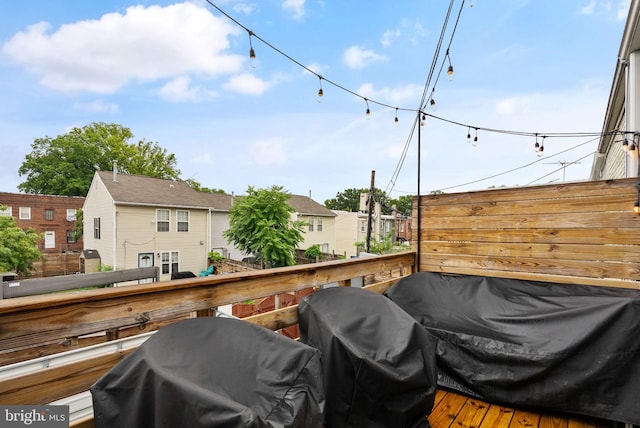 exterior space with a grill, a residential view, and a wooden deck