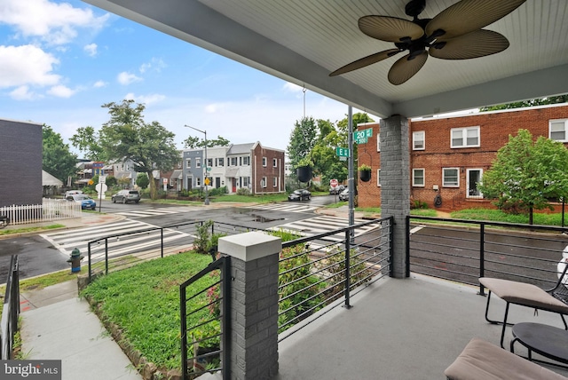 exterior space featuring a ceiling fan and a residential view