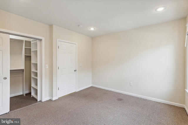 unfurnished bedroom featuring a closet, recessed lighting, carpet flooring, and baseboards