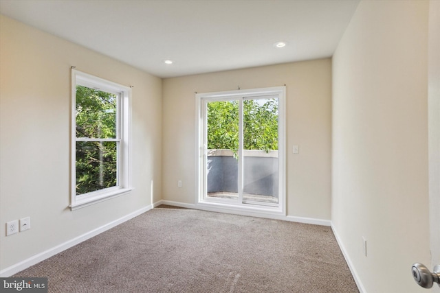 unfurnished room with carpet floors, recessed lighting, and baseboards