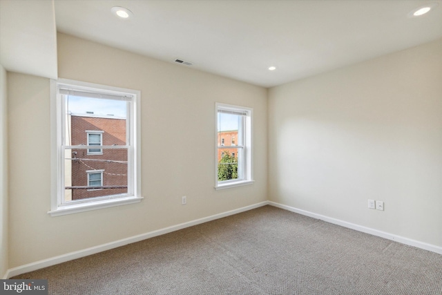 unfurnished room featuring baseboards, carpet, visible vents, and recessed lighting