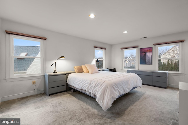 bedroom featuring light carpet, baseboards, visible vents, and recessed lighting