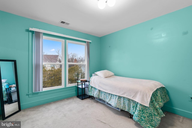 carpeted bedroom with visible vents and baseboards