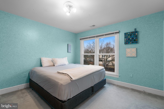 bedroom with carpet, visible vents, and baseboards