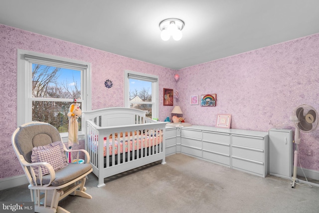 bedroom featuring wallpapered walls and baseboards