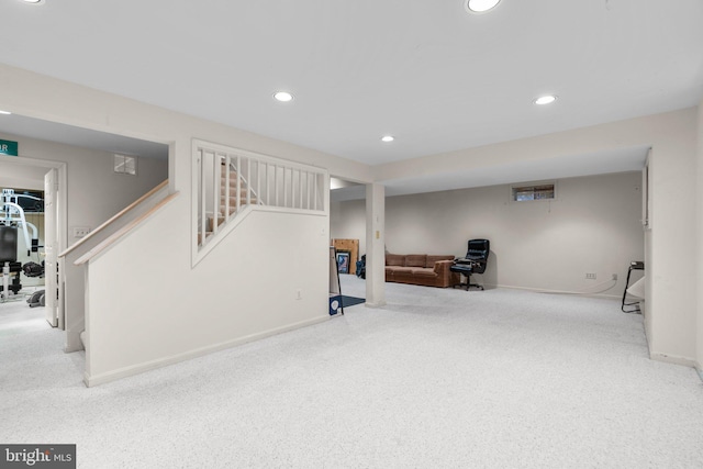 finished basement with stairs, baseboards, carpet flooring, and recessed lighting