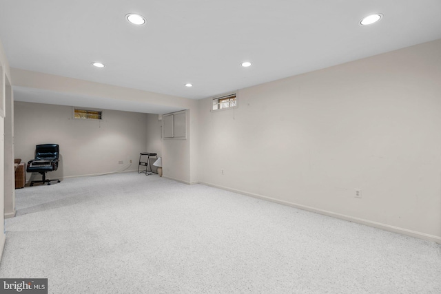 basement featuring recessed lighting, light carpet, and baseboards