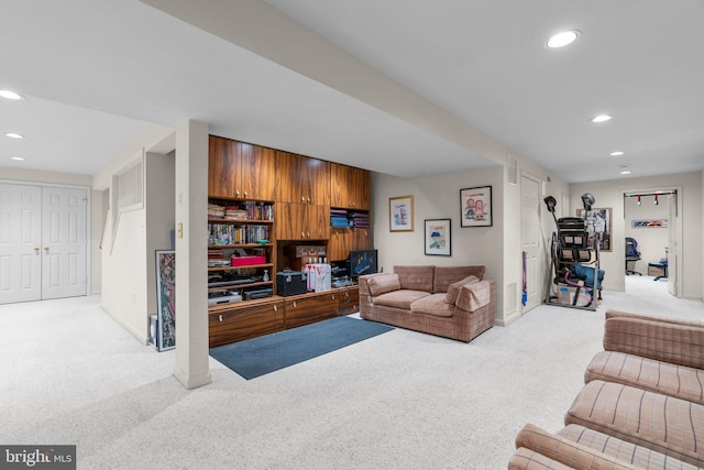 carpeted living area featuring visible vents, baseboards, and recessed lighting