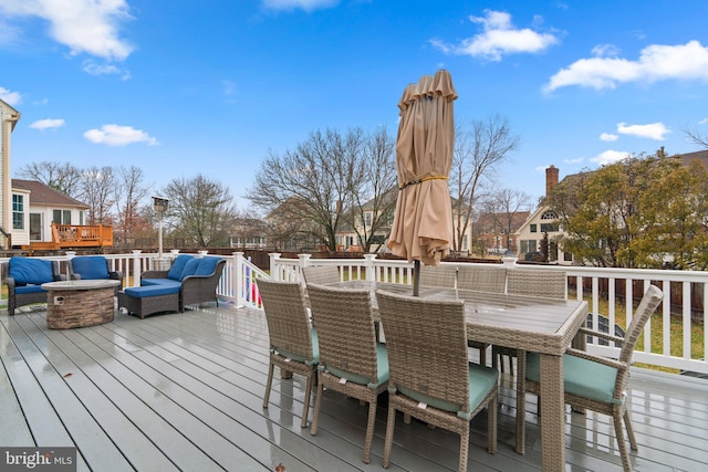 wooden terrace featuring a fire pit and outdoor dining area