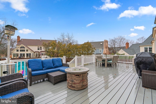 wooden deck featuring grilling area, an outdoor hangout area, and outdoor dining space