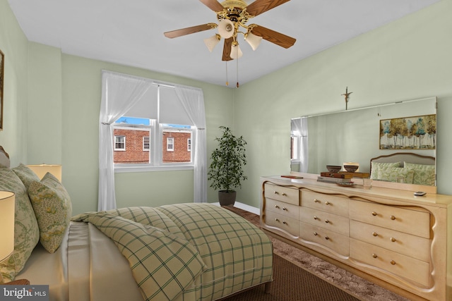 carpeted bedroom featuring a ceiling fan and baseboards