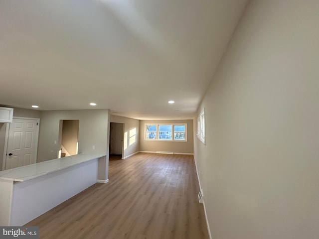 empty room with baseboards, visible vents, light wood-style flooring, and recessed lighting