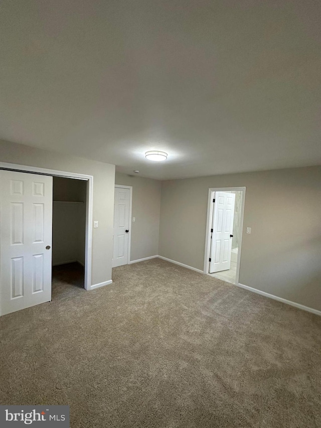 unfurnished bedroom with carpet floors and baseboards