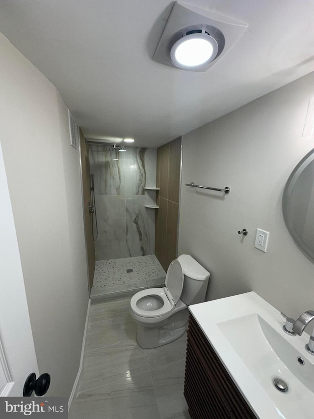 bathroom featuring vanity, toilet, and walk in shower