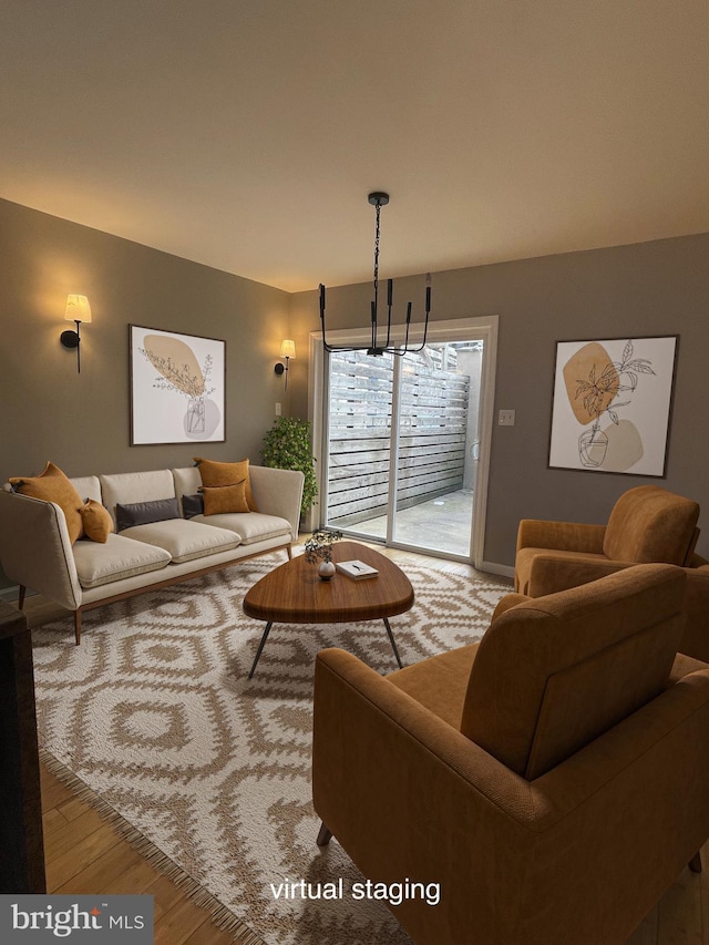 living area with a notable chandelier and light wood-style flooring