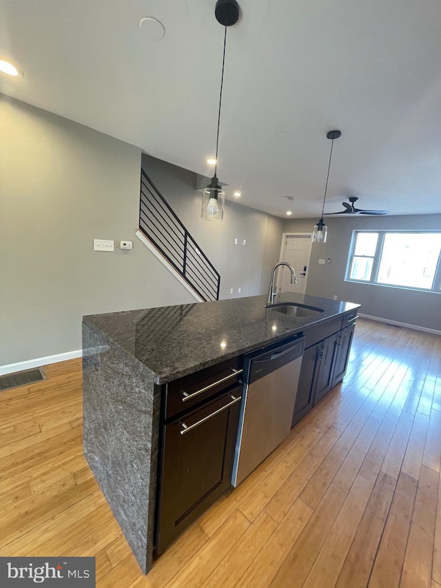 kitchen featuring light wood-style floors, a sink, ceiling fan, and dishwasher