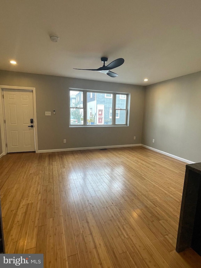 unfurnished living room with recessed lighting, light wood-type flooring, baseboards, and a ceiling fan