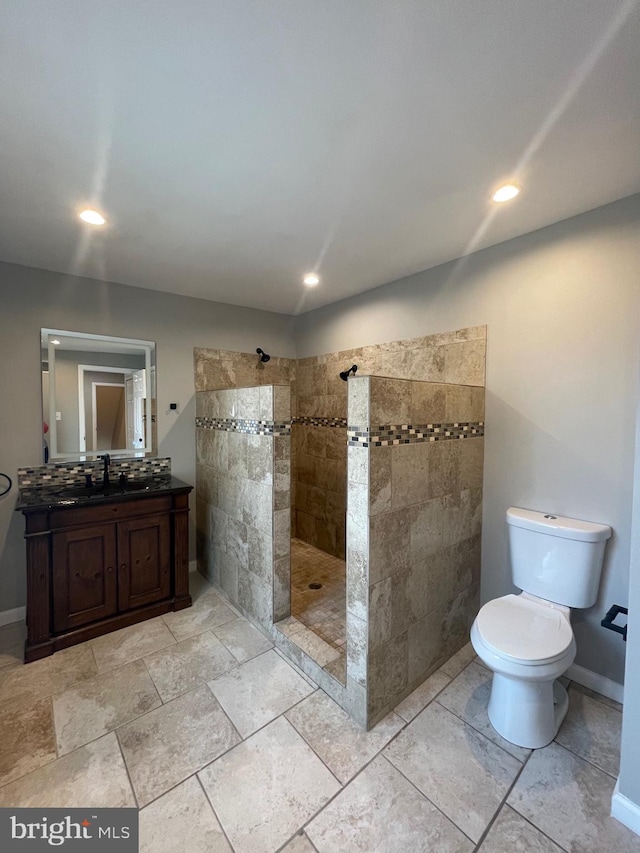 bathroom with vanity, recessed lighting, walk in shower, and toilet