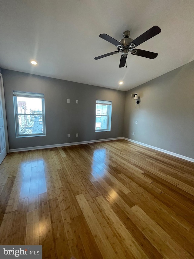 spare room featuring baseboards, a ceiling fan, recessed lighting, and wood finished floors