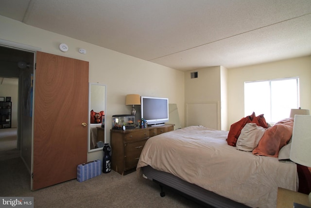 carpeted bedroom featuring visible vents