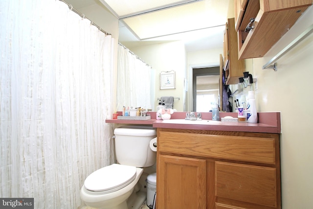 full bathroom with toilet, curtained shower, and vanity