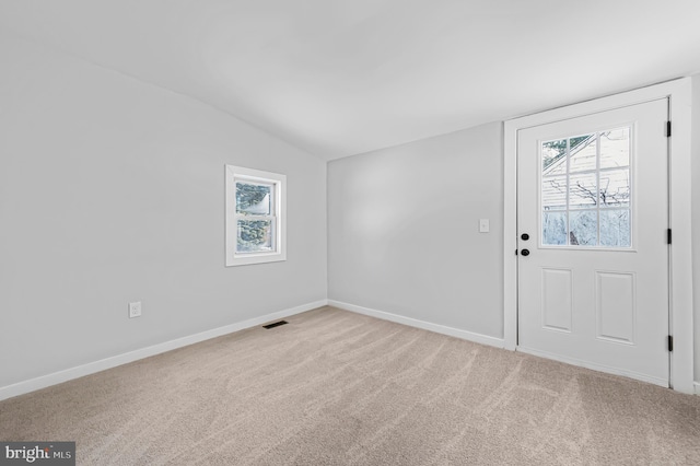 interior space featuring lofted ceiling, visible vents, and baseboards