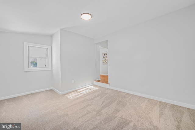 empty room with baseboards and carpet flooring