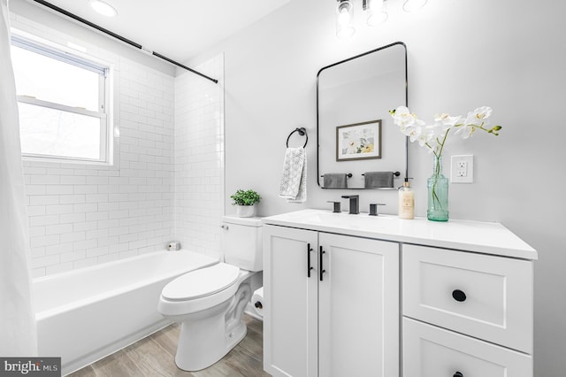 full bathroom with toilet, shower / washtub combination, wood finished floors, and vanity