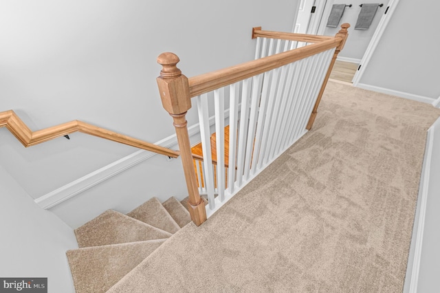 staircase with carpet flooring and baseboards