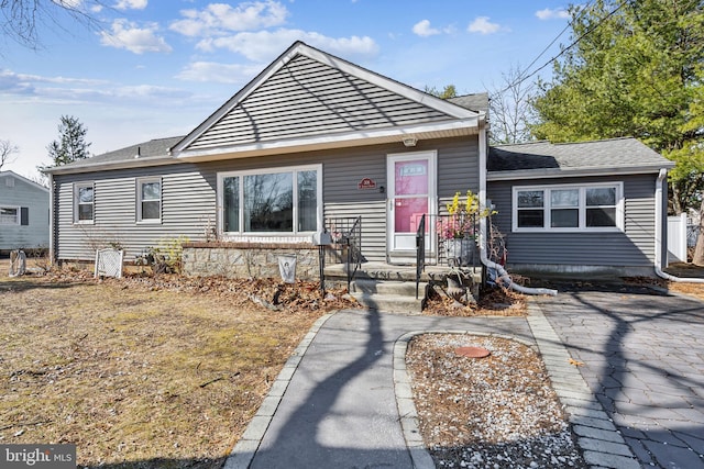 bungalow featuring a shingled roof