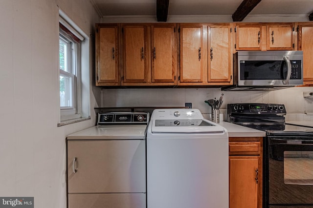 washroom with laundry area, crown molding, and separate washer and dryer