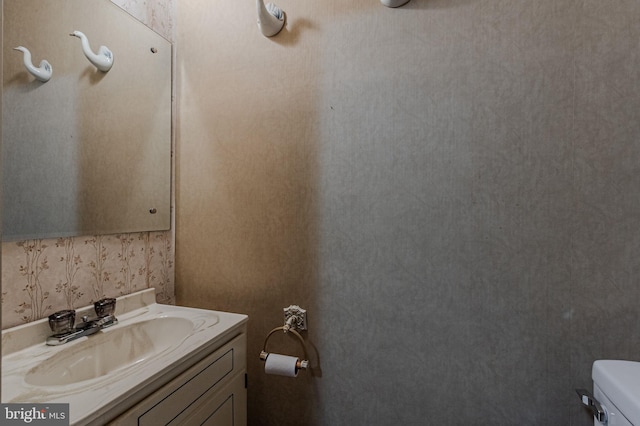 bathroom featuring toilet and vanity