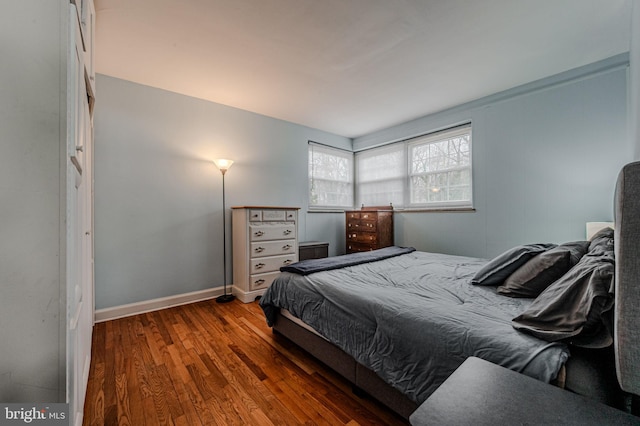 bedroom with baseboards and wood finished floors