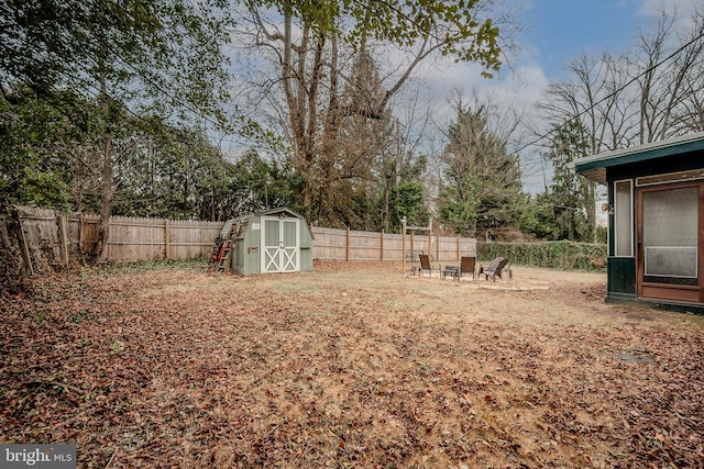 view of yard with an outbuilding, a storage unit, and a fenced backyard