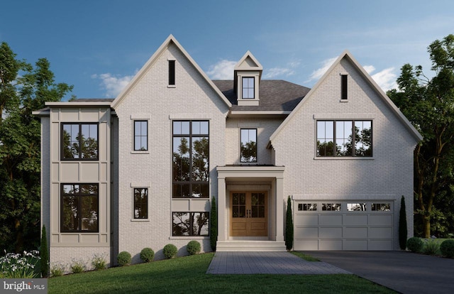 view of front of home featuring french doors, brick siding, driveway, and an attached garage