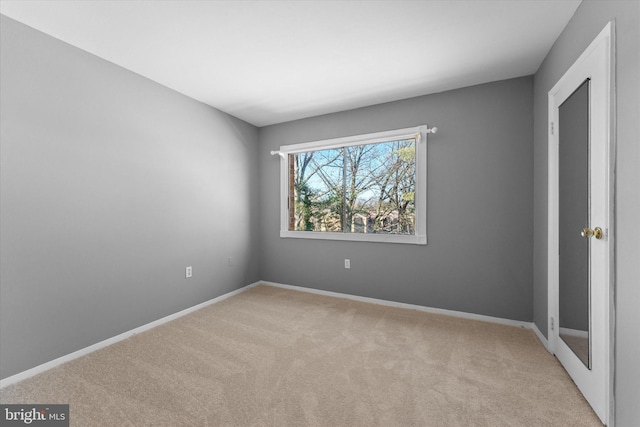 unfurnished bedroom featuring carpet floors and baseboards