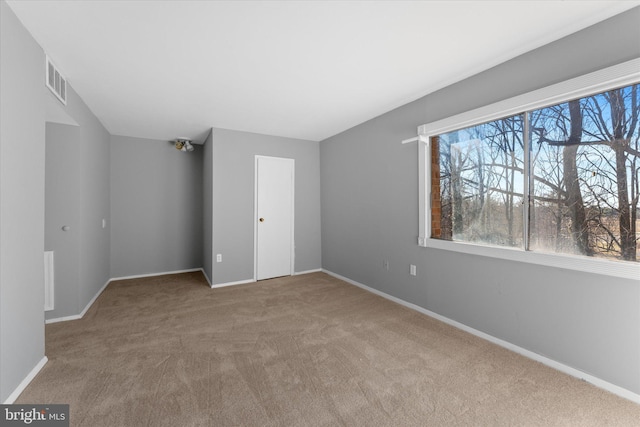 unfurnished bedroom featuring visible vents, baseboards, and carpet flooring