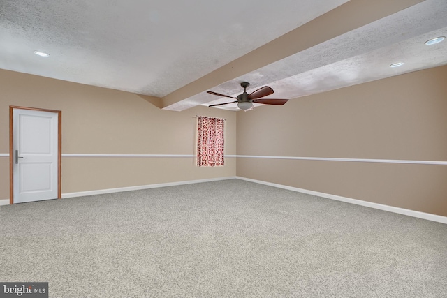 empty room with carpet floors, recessed lighting, a textured ceiling, and baseboards