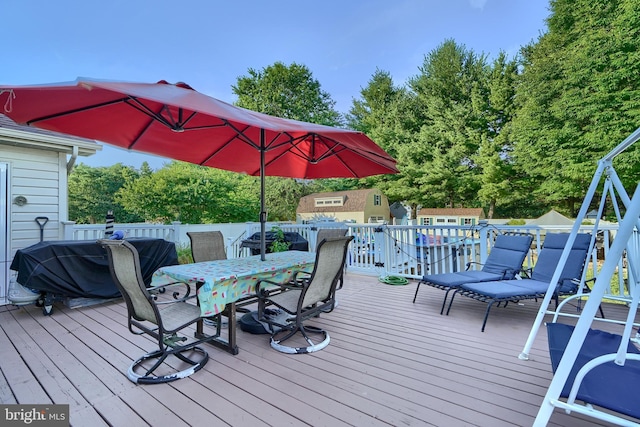 wooden terrace with outdoor dining area