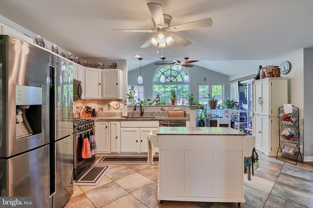 kitchen featuring light stone counters, white cabinetry, a sink, and black appliances