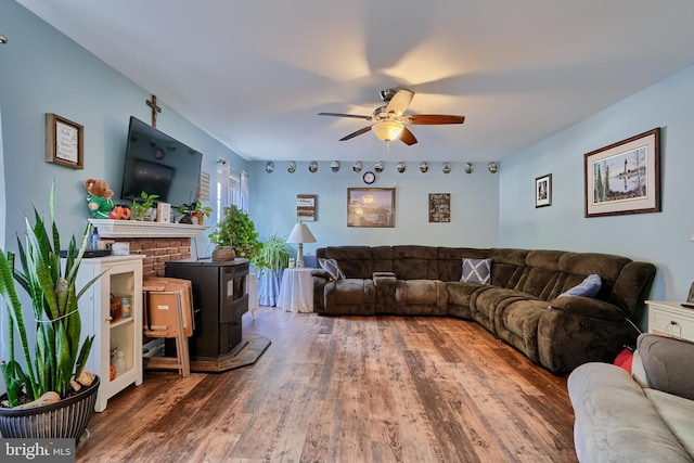 living room with ceiling fan and wood finished floors