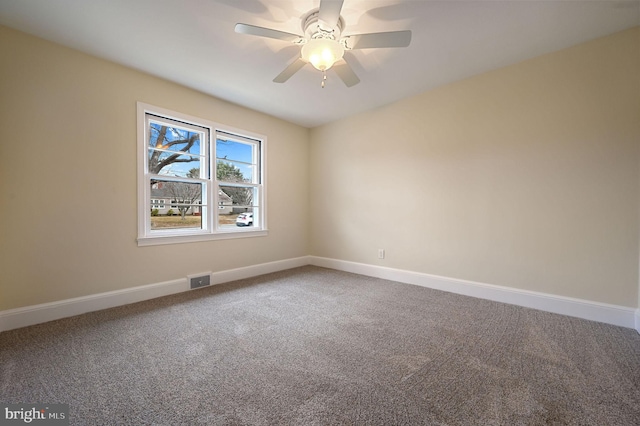 carpeted spare room featuring visible vents, ceiling fan, and baseboards