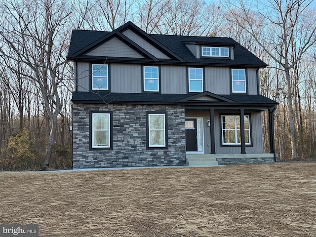 view of front of house with crawl space, stone siding, and a shingled roof