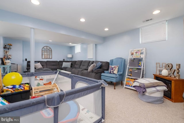 carpeted living area featuring visible vents and recessed lighting