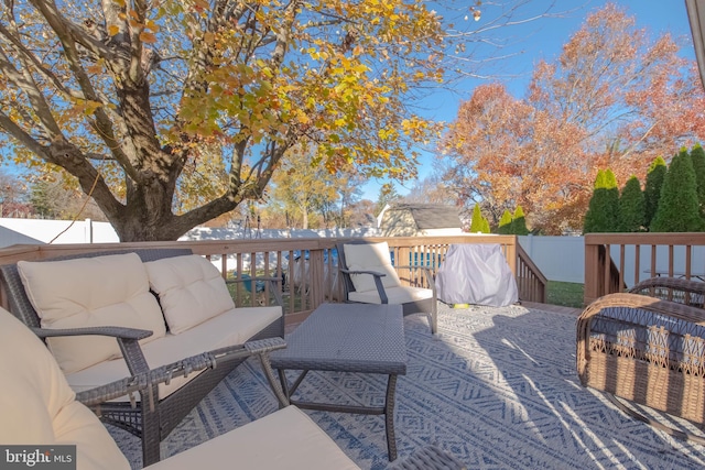 wooden deck with fence and outdoor lounge area