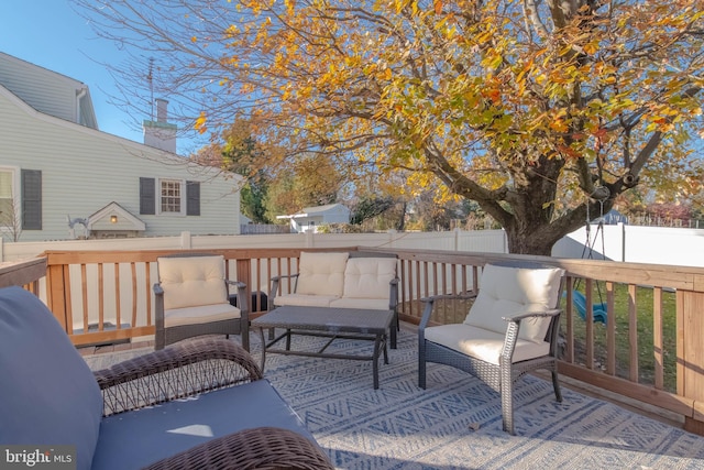 deck featuring outdoor lounge area and a fenced backyard