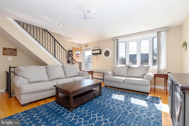 living area featuring stairs, recessed lighting, wood finished floors, and baseboards