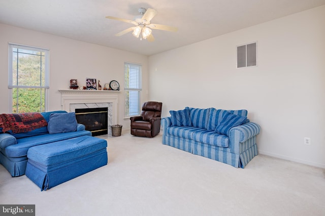 living room featuring a wealth of natural light, visible vents, and carpet flooring