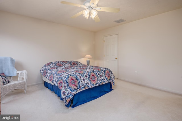 carpeted bedroom featuring ceiling fan, visible vents, and baseboards